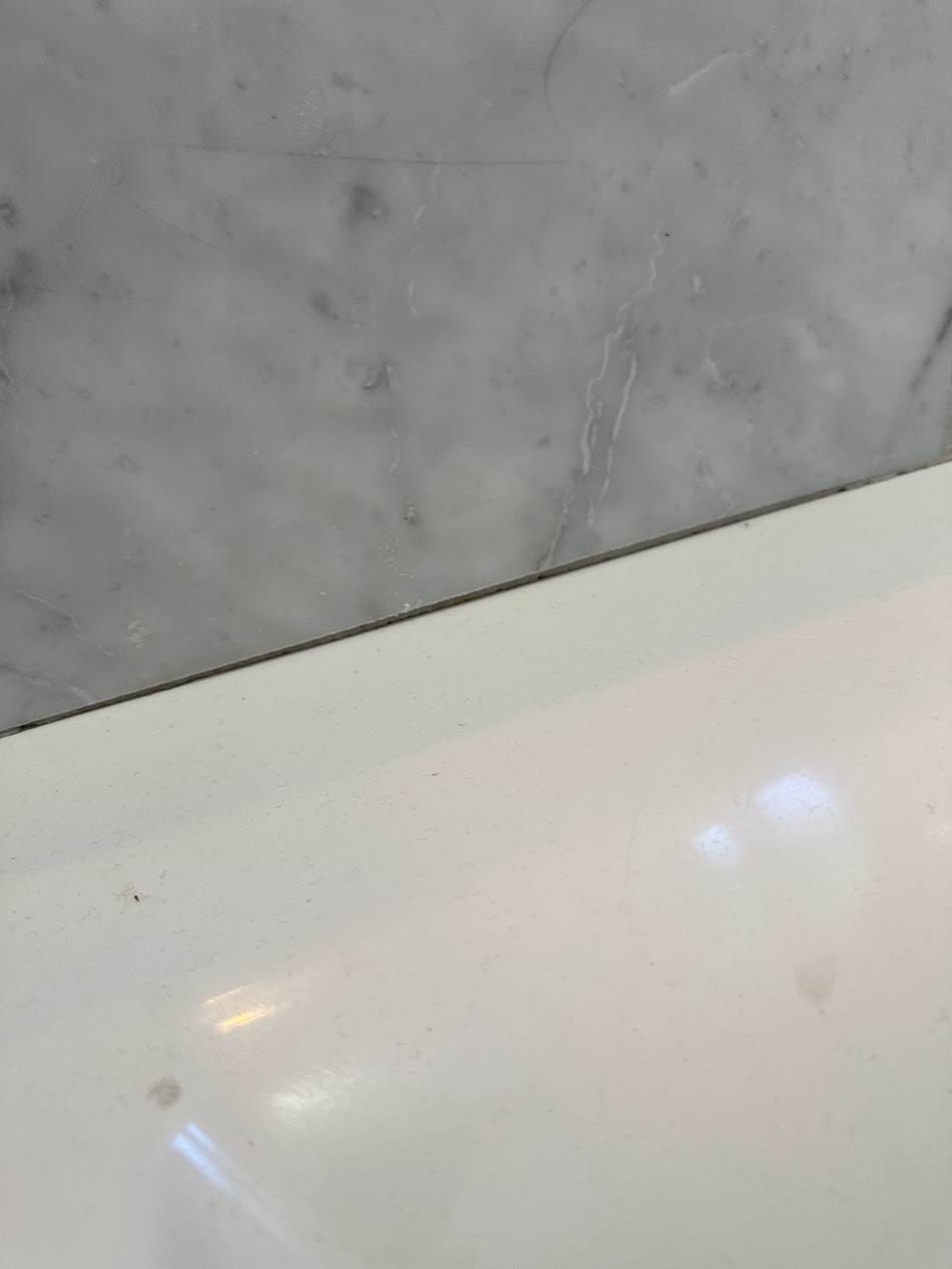 Close-up of the tub edge being resealed in West LA, CA 90025