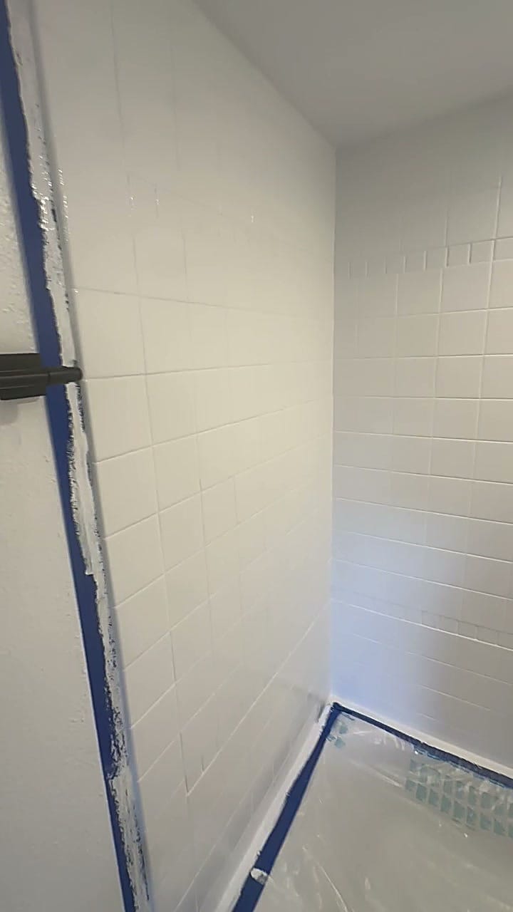 Shower tile masked and being repainted white in Hollywood, CA 90028