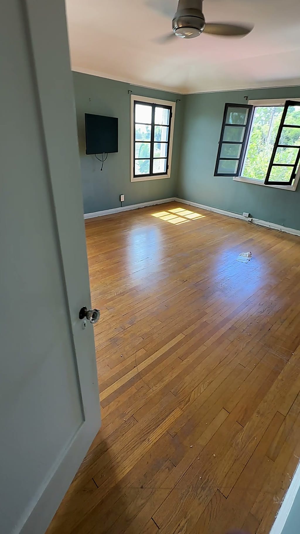 Faded, worn hardwood bedroom floor before refinishing in Beverlywood, CA 90035