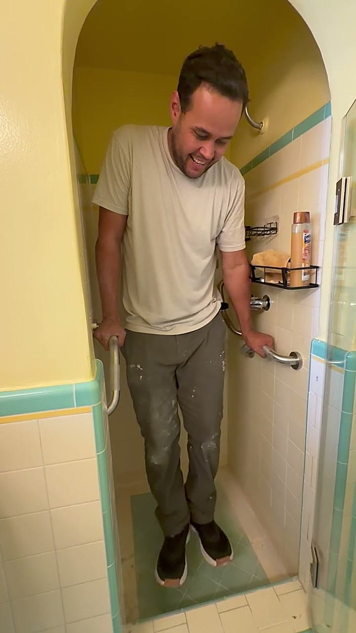 Eddie load-testing the new grab bars with his full body weight, feet off the shower floor in Beverlywood, CA 90035