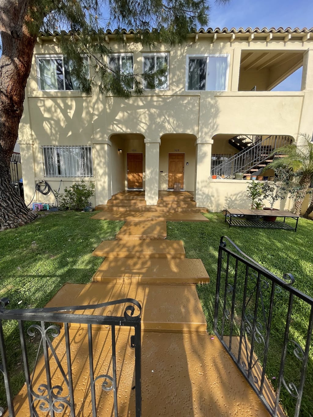 The entry walkway from the front gate repainted warm terracotta in Mid-City, CA 90036