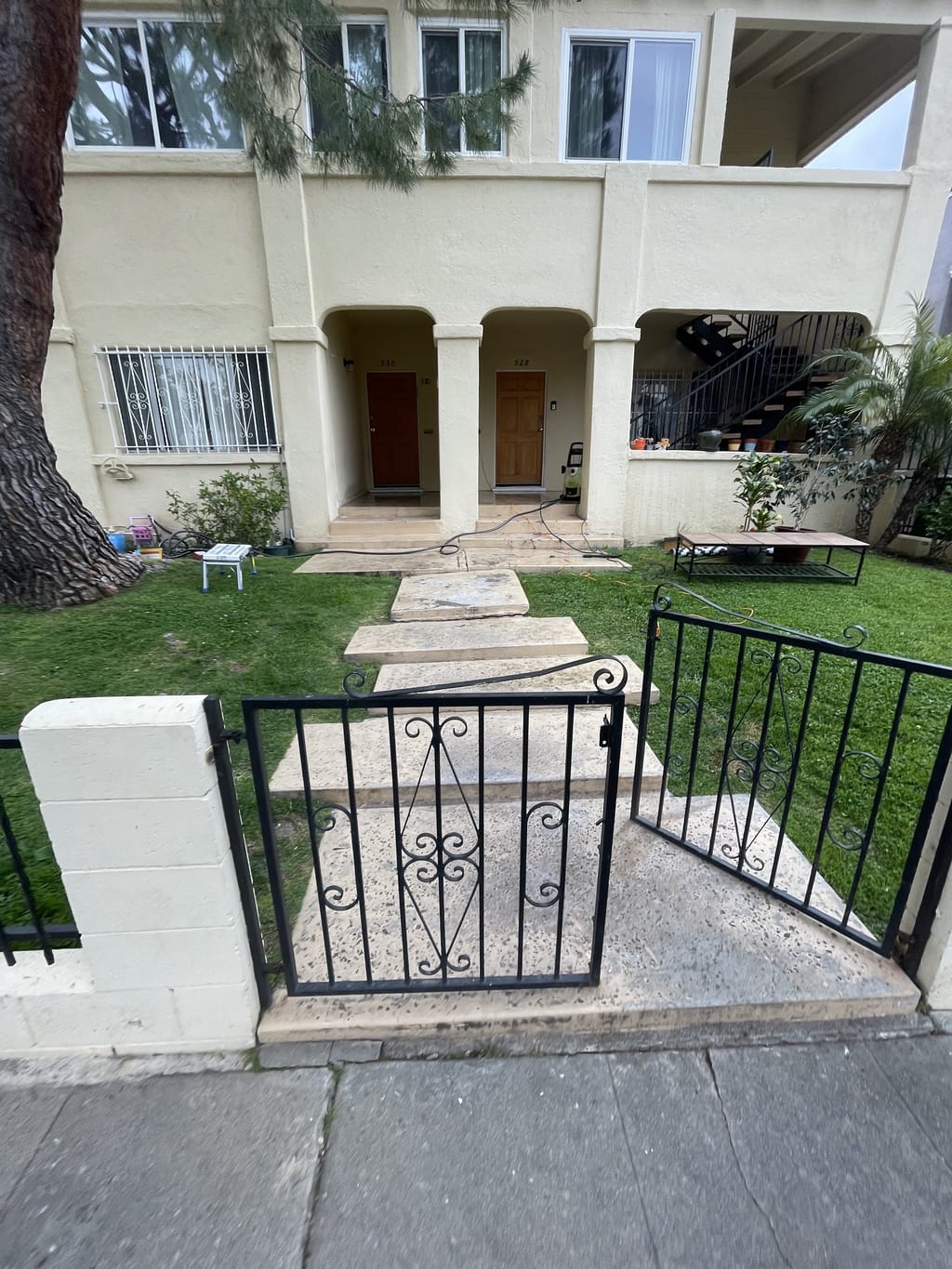 Worn gray concrete entry walkway from the front gate before painting in Mid-City, CA 90036