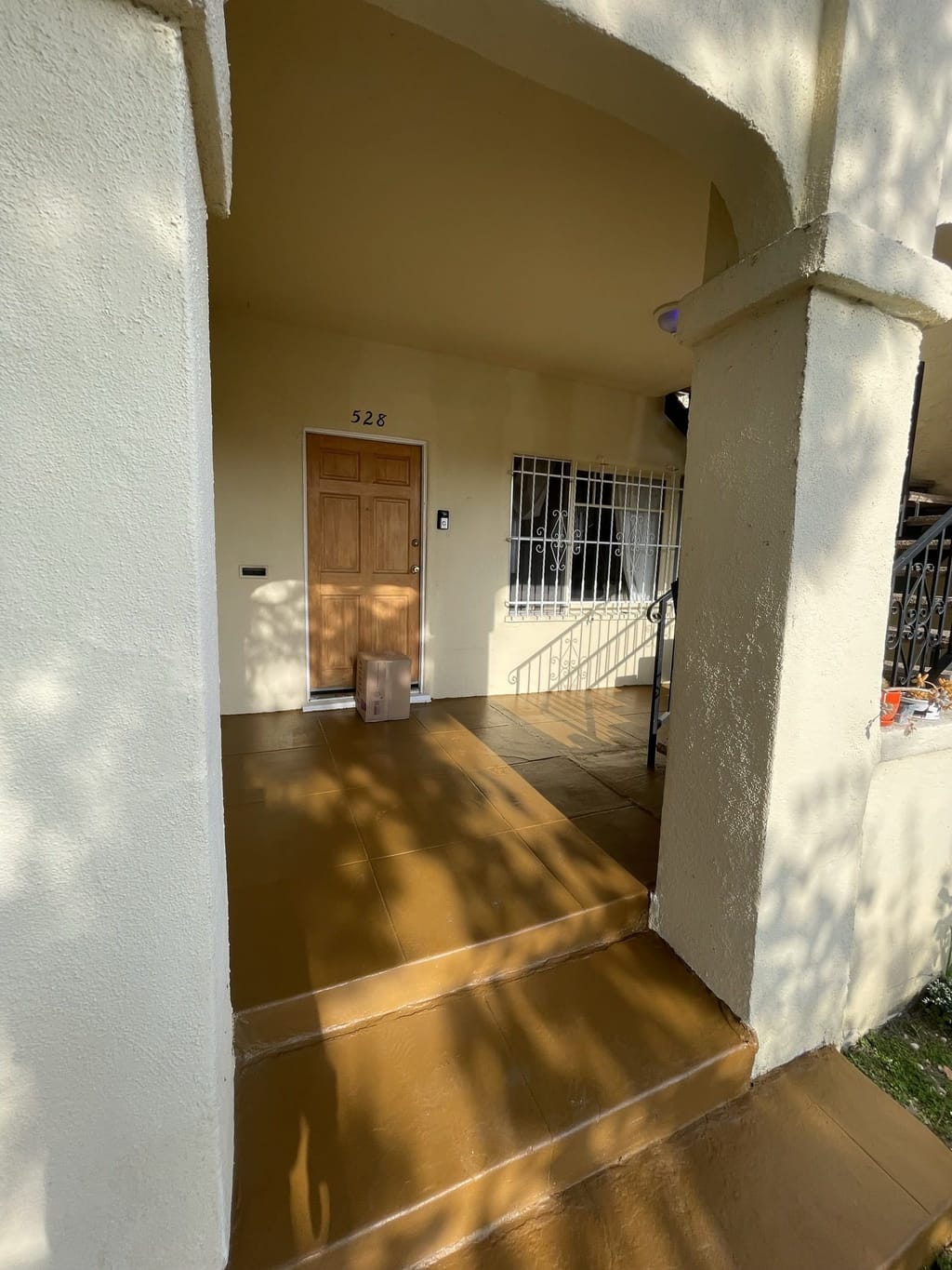 Concrete entry walkway and steps repainted in a warm terracotta finish in Mid-City, CA 90036