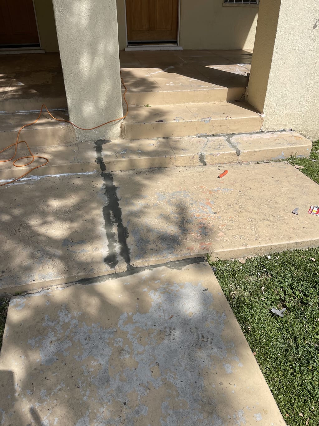 Close view of cracks being prepped in a concrete walkway in Mid-City, CA 90036