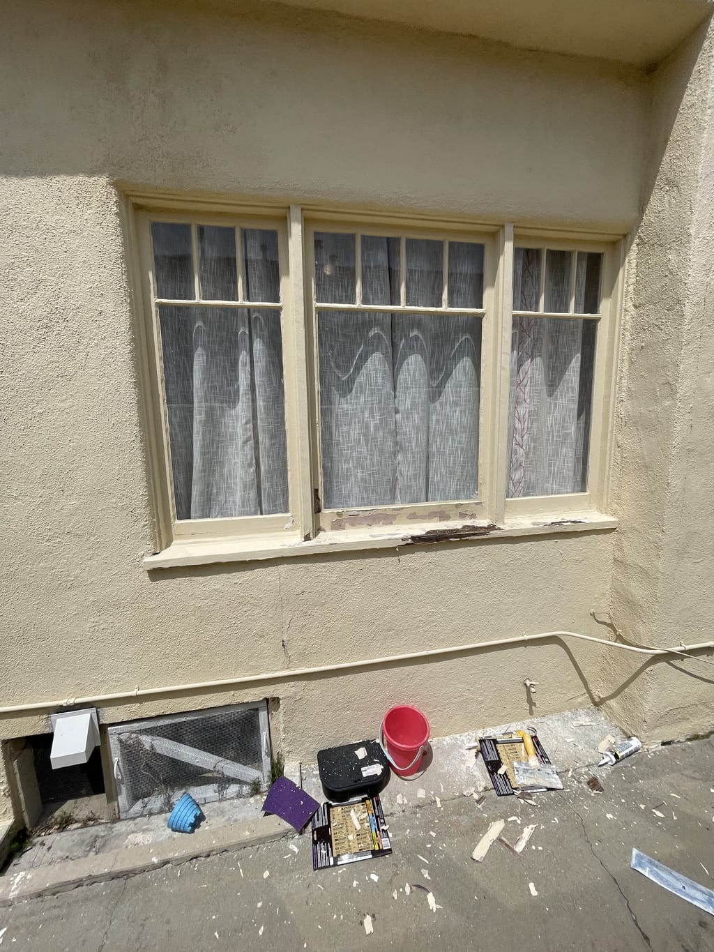 Larger window with damaged exterior wood before repair in Mid-City, CA 90036