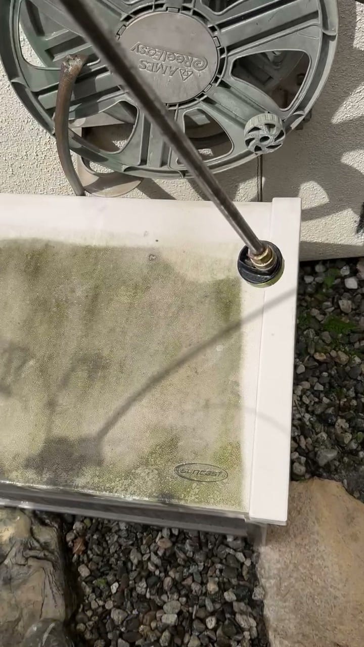 Power washer lifting grime and algae off an outdoor surface in Brentwood, CA 90049