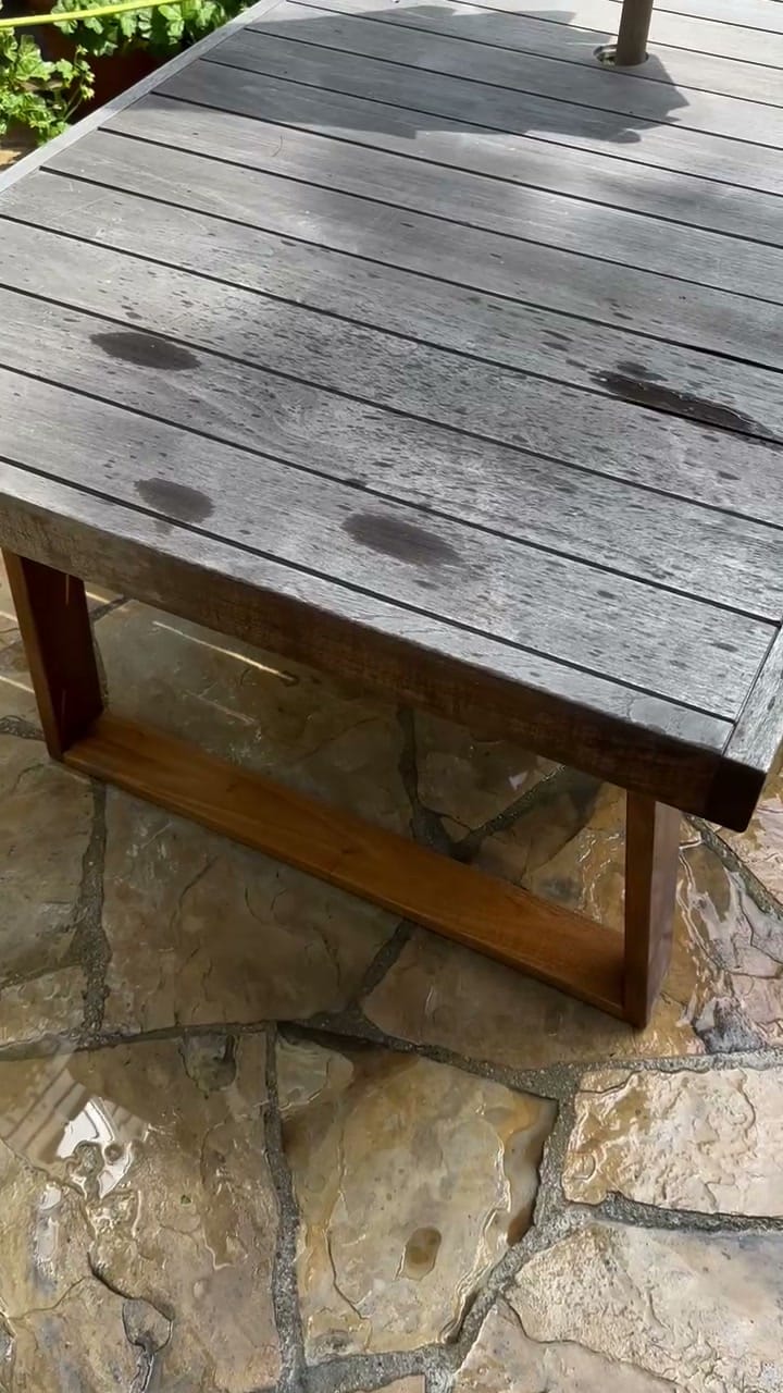 Gray, weathered patio table before power washing in Brentwood, CA 90049