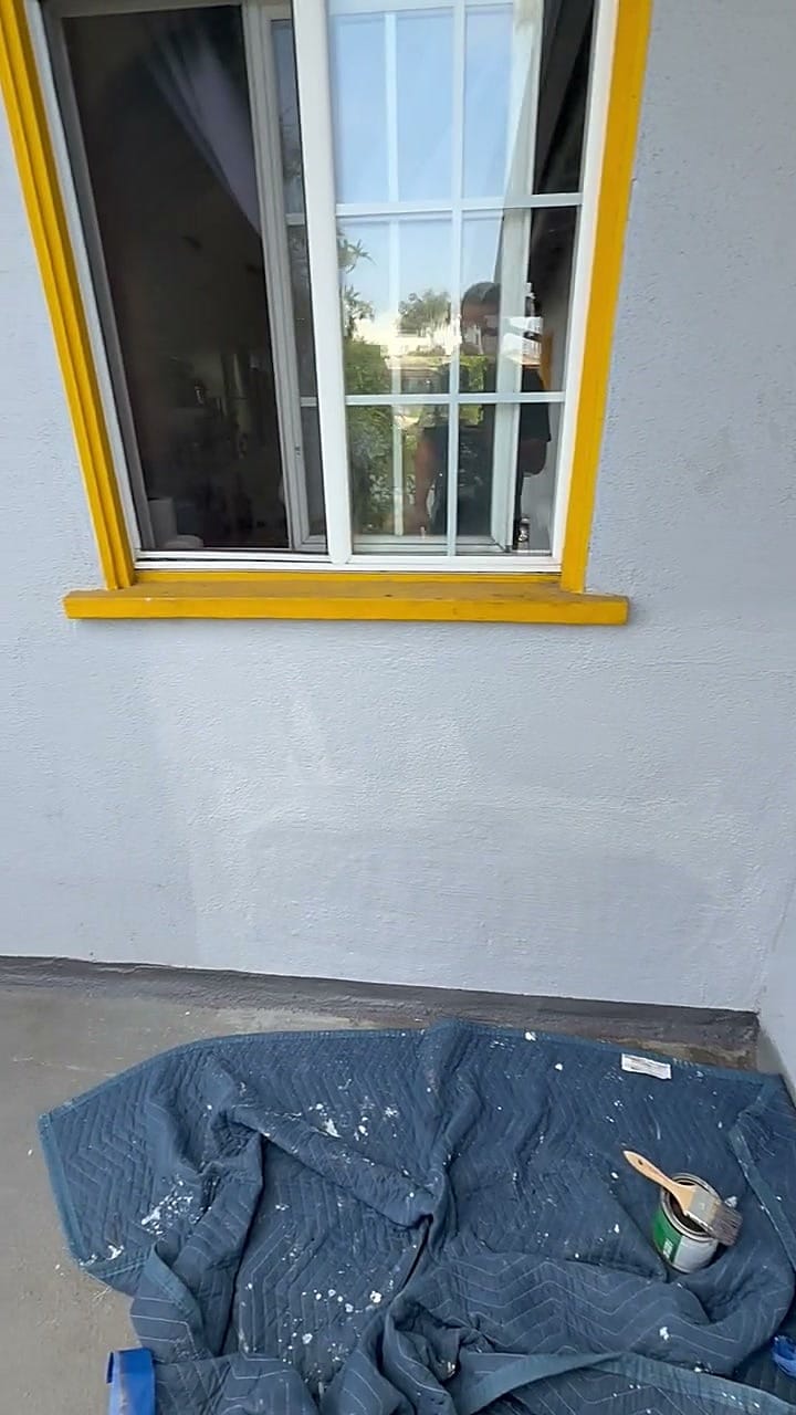The repaired exterior wall below the window, textured, primed and painted to match in Mar Vista, CA 90066