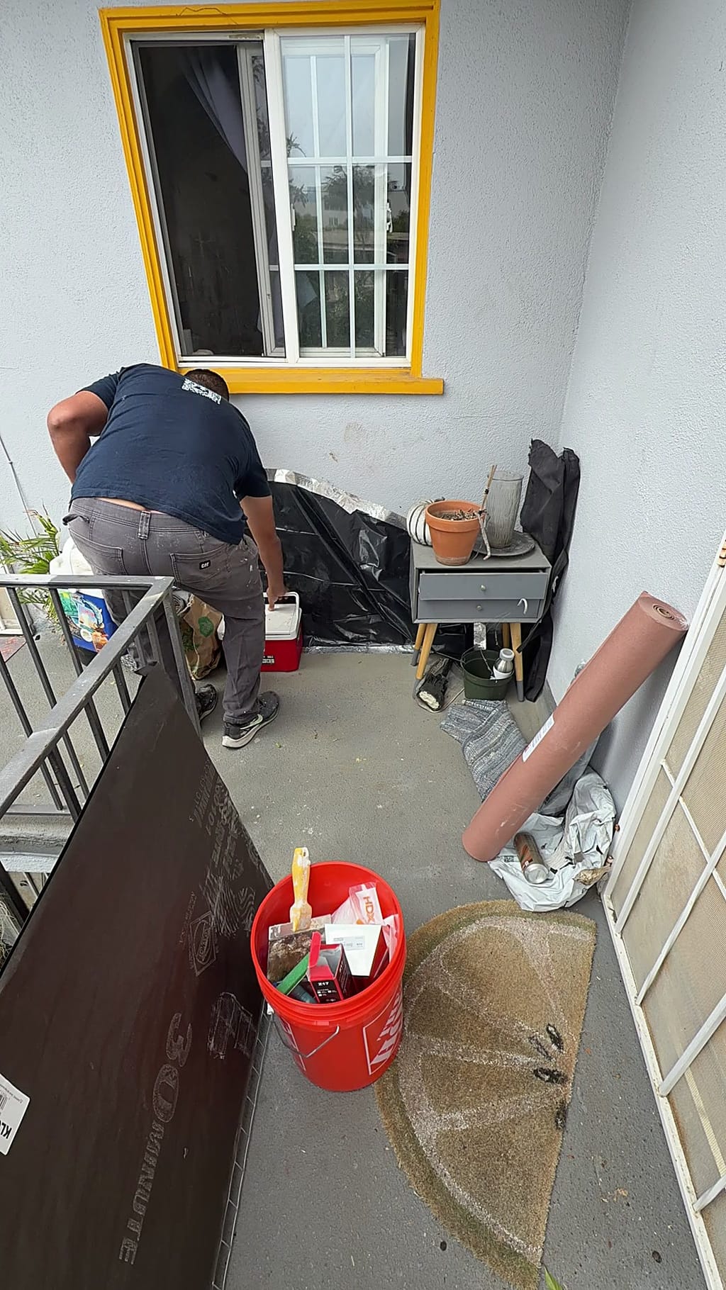 Exterior wall corner with the opening taped over in plastic before the stucco repair in Mar Vista, CA 90066
