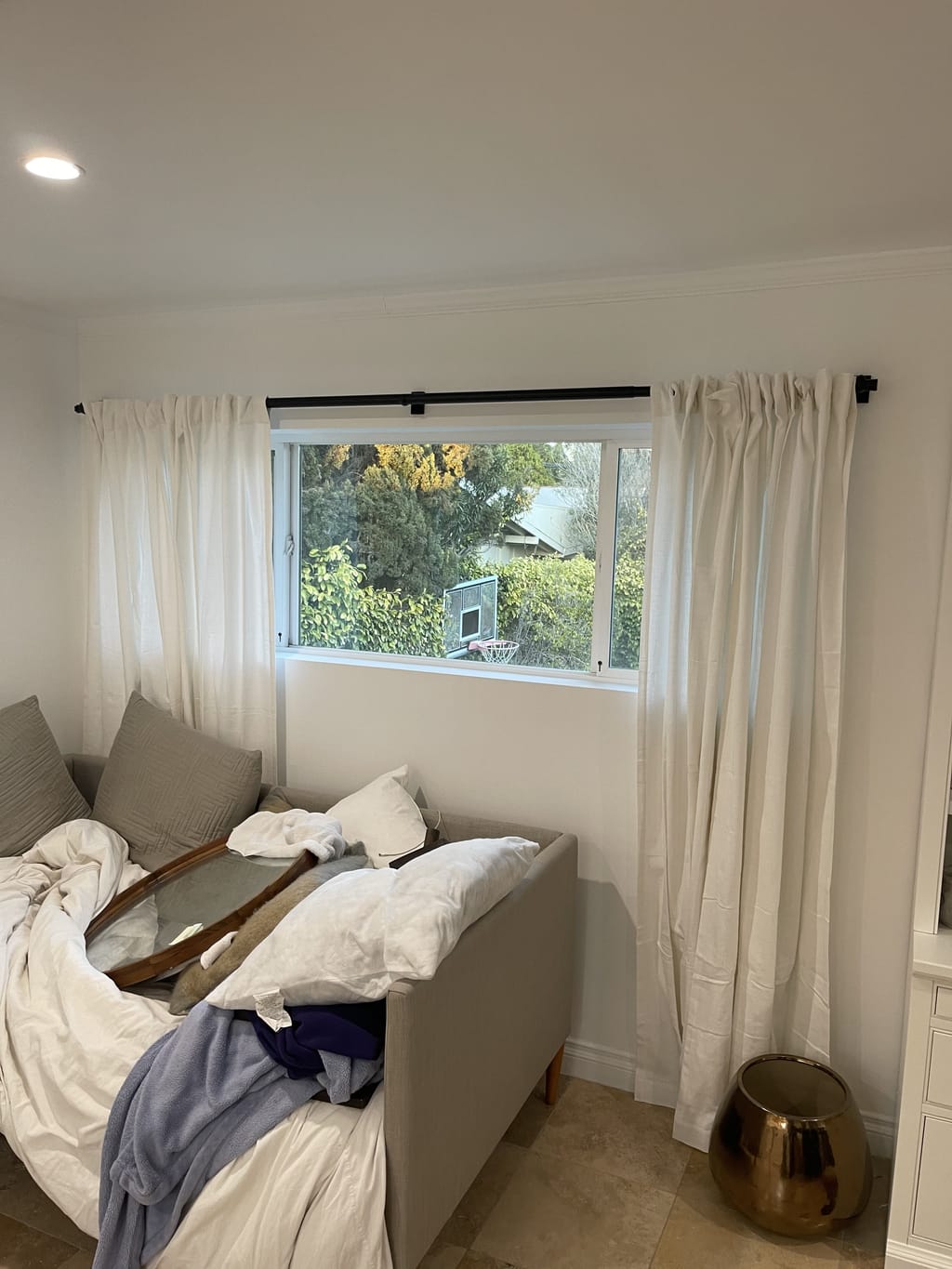 Cream linen curtains hung evenly over a second window in Bel Air, CA 90077