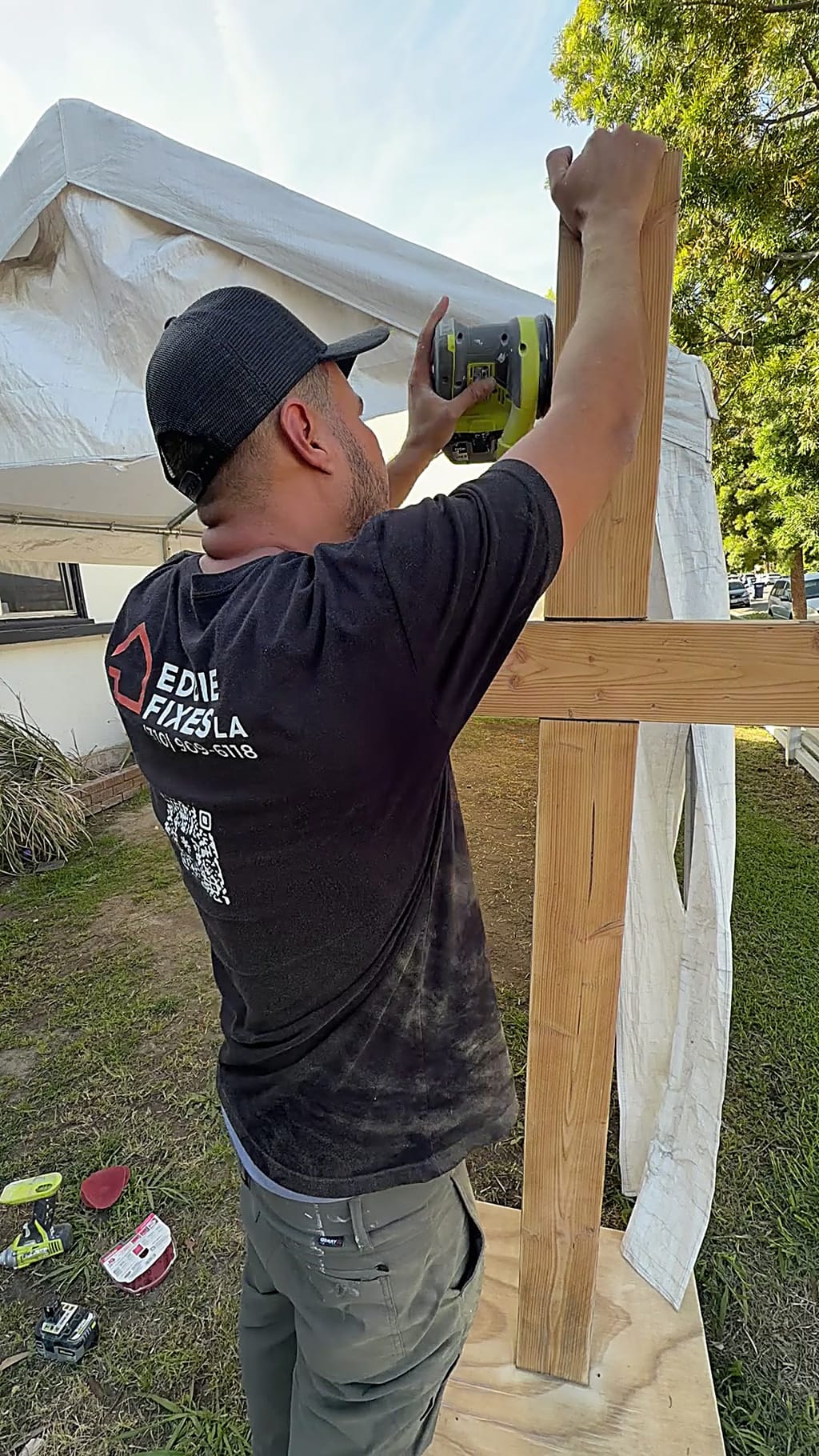 Sanding the wood cross back to fresh wood in Culver City, CA 90232