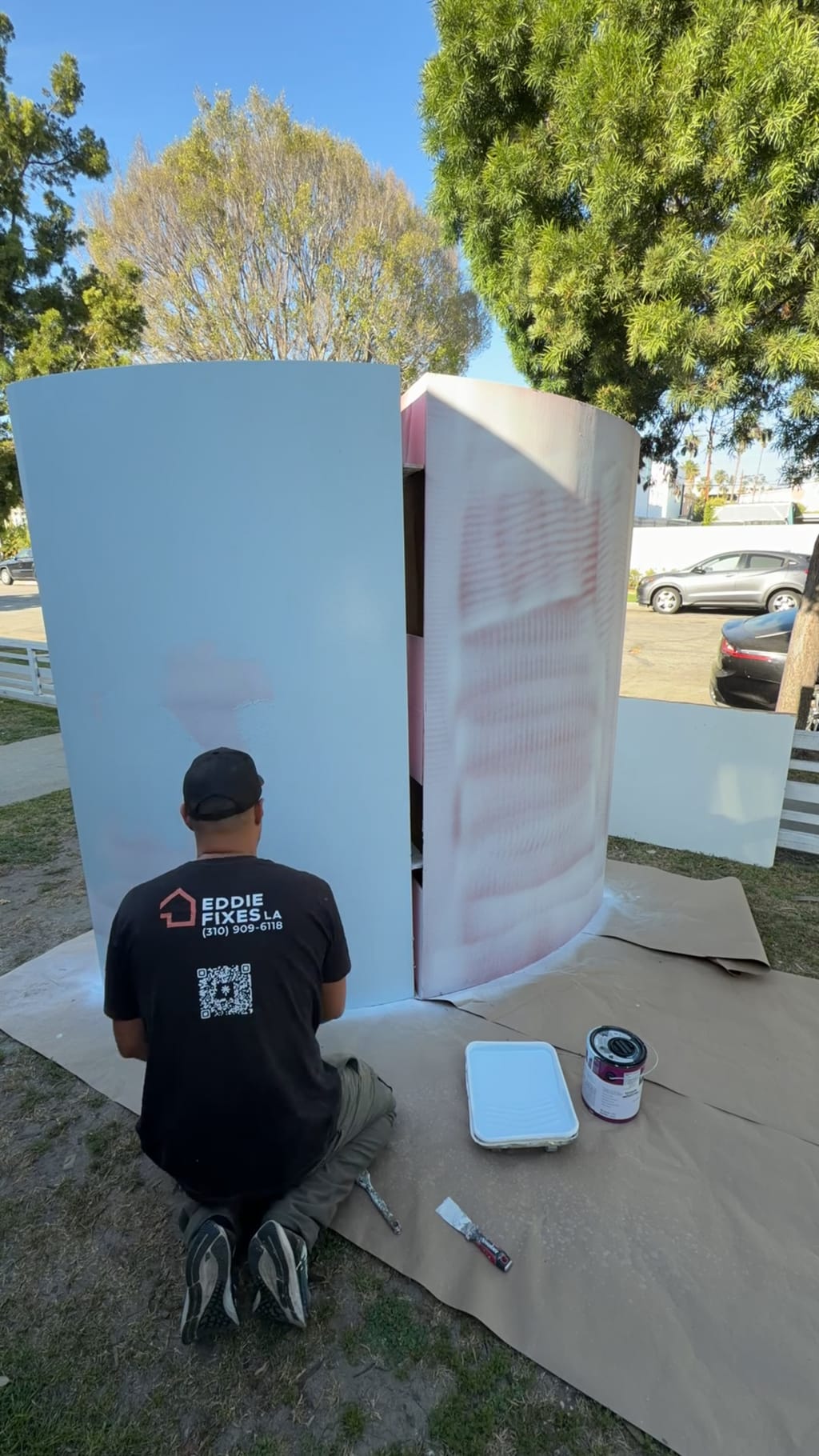 Eddie in an Eddie Fixes LA shirt priming the curved photo booth panels white in Culver City, CA 90232