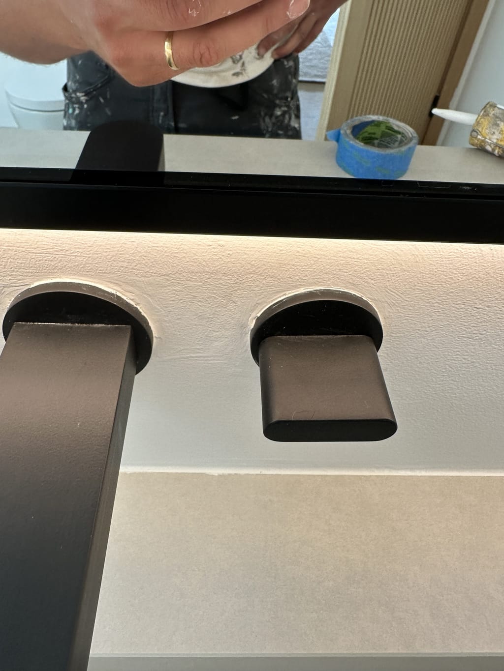 Close-up of rough finish around black faucet handle escutcheons in Malibu, CA 90265