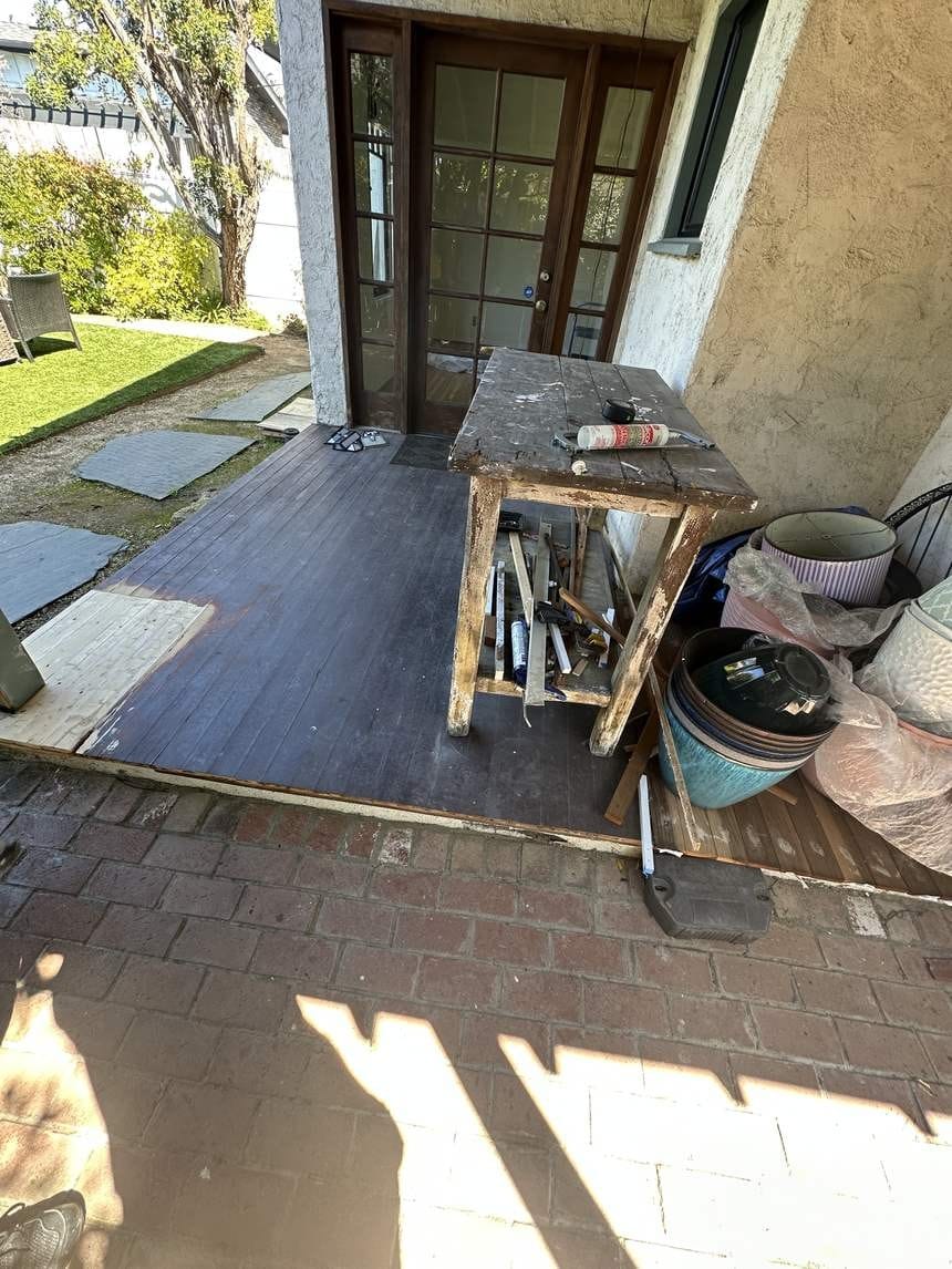 Faded, worn deck by the door before refinishing in Venice, CA 90291