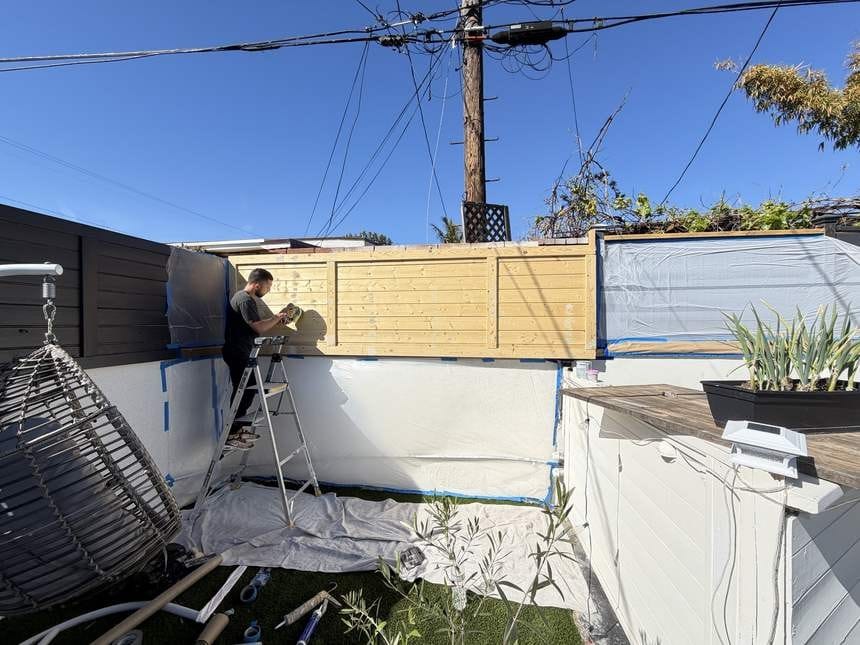Eddie on a ladder working the wood fence area in Playa del Rey, CA 90293