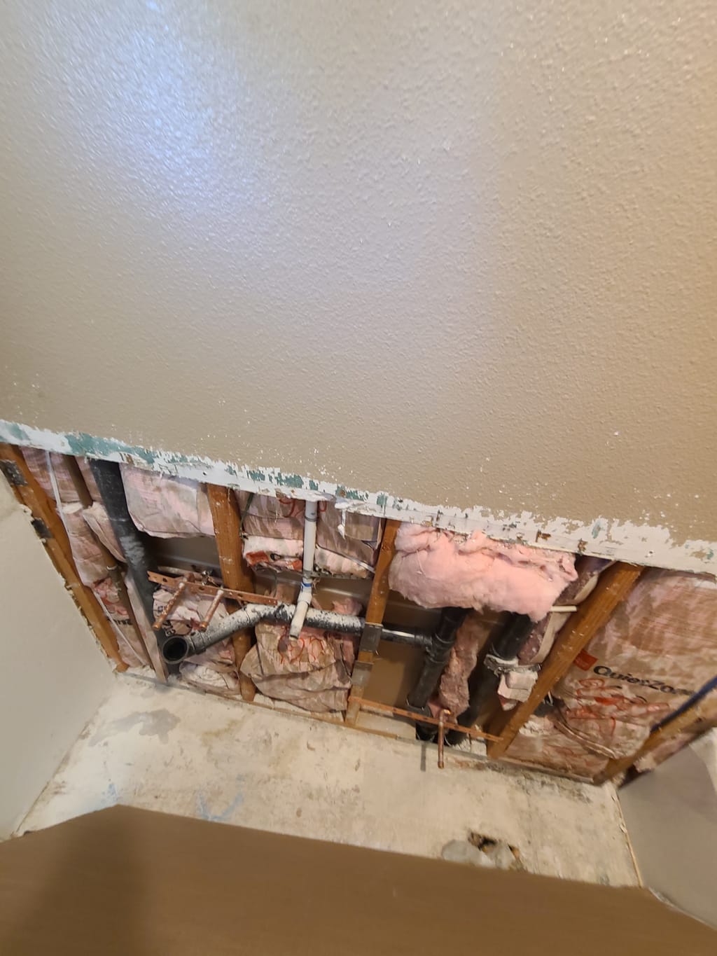 Bathroom wall opened up after a leak, exposing studs, insulation and plumbing in Calabasas, CA 91302