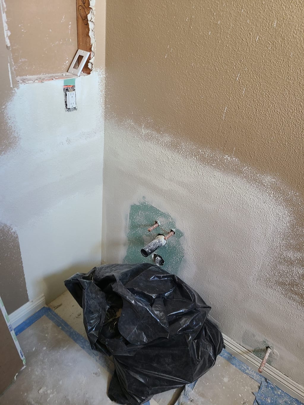 Green moisture-resistant drywall installed and first coat of mud around the plumbing in Calabasas, CA 91302