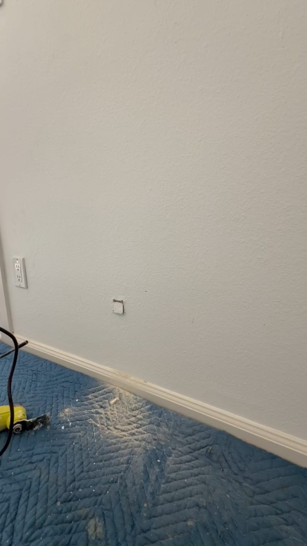 Interior wall with a small marked opening before the dog door cut in Canoga Park, CA 91303