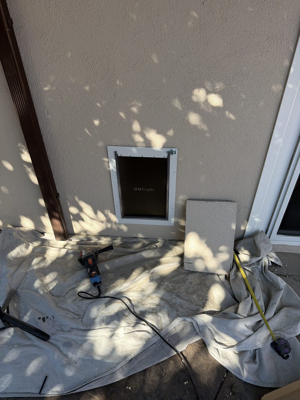 Finished dog door installed in an exterior stucco wall in Canoga Park, CA 91303