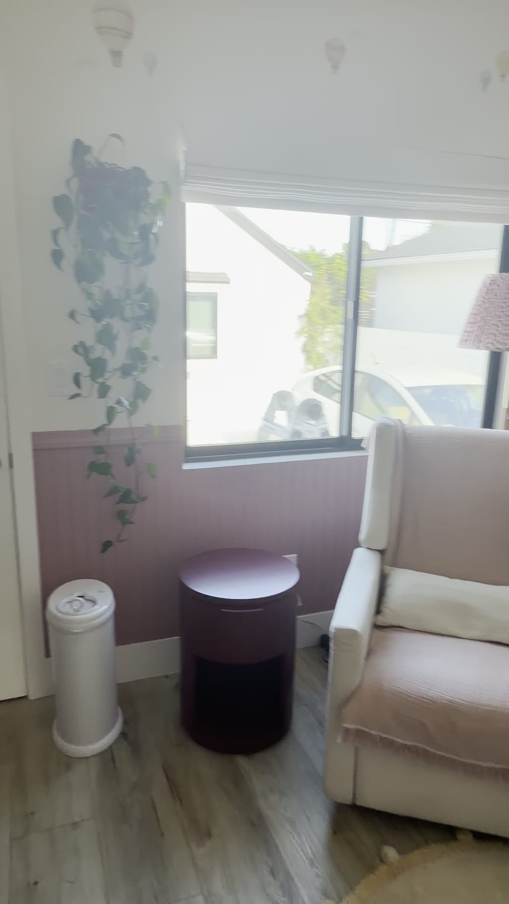 Nursery corner with mauve wainscoting wrapping around the crib and window in Burbank, CA 91506