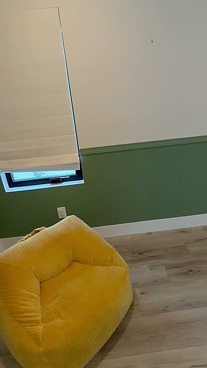 Finished nursery with green wainscoting, cream walls and wood floor in Burbank, CA 91506