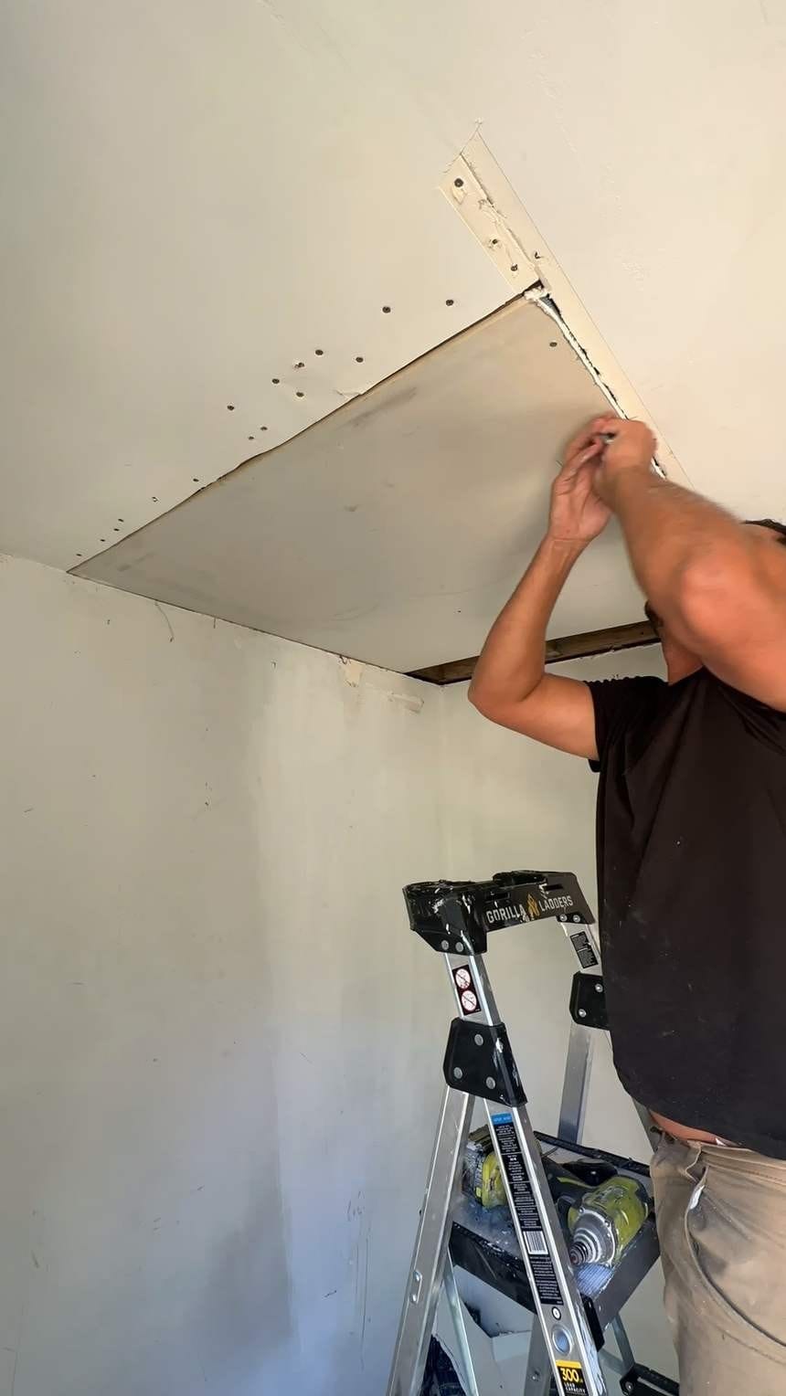 Fitting a drywall panel to the ceiling in North Hollywood, CA 91602