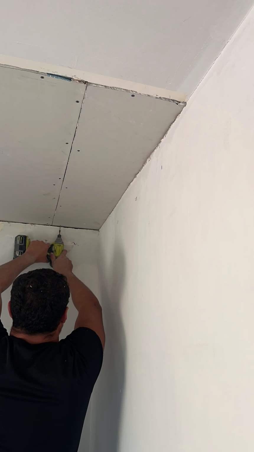 Screwing a second ceiling drywall panel in North Hollywood, CA 91602