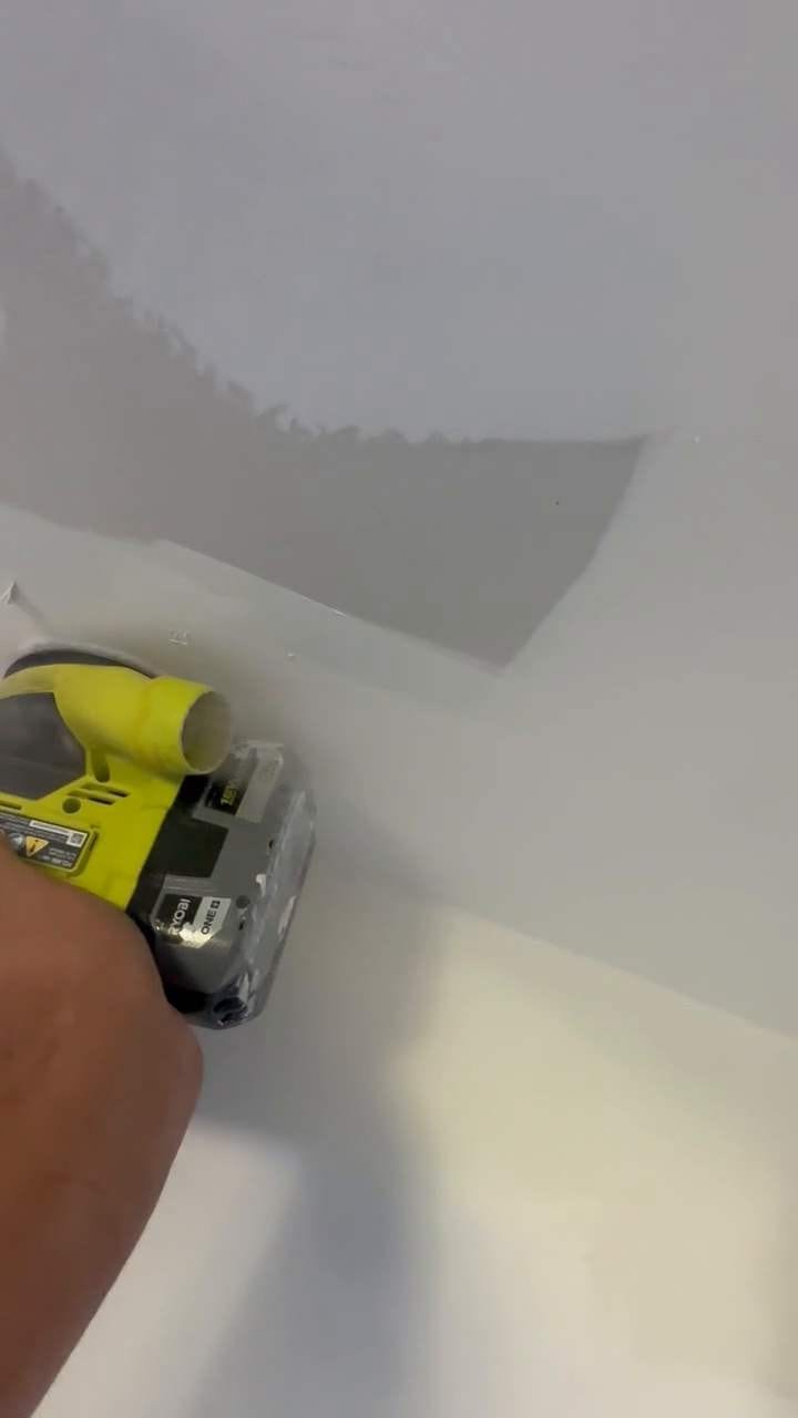 Sanding the patched ceiling smooth in North Hollywood, CA 91602
