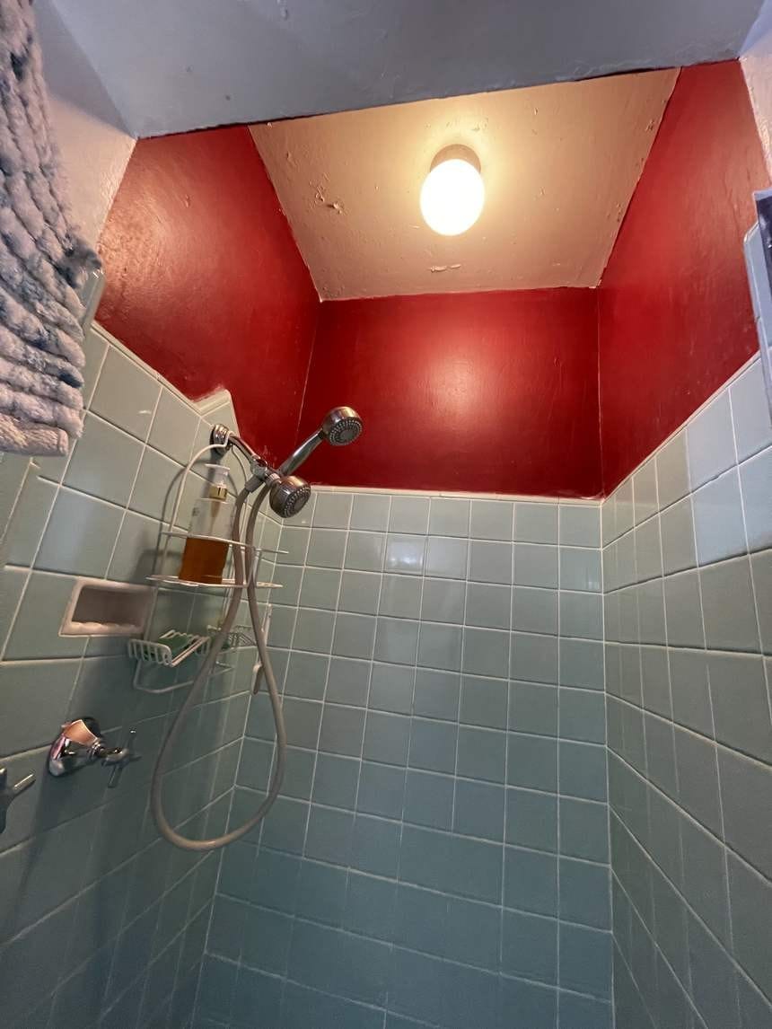 Bold red bathroom shower wall before repainting in Studio City, CA 91604
