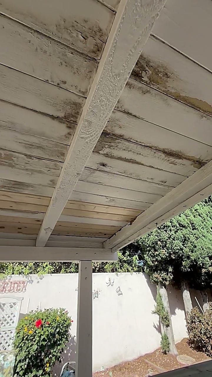 Weathered, leak-stained outdoor wood patio ceiling before repainting in Irvine, CA 92618
