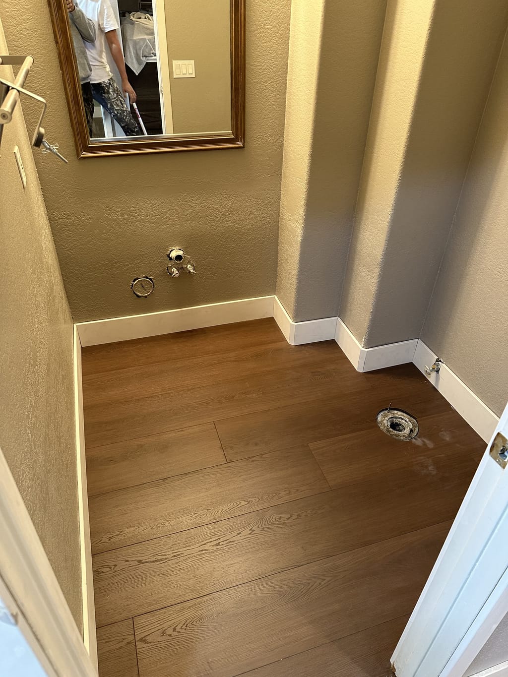 Finished utility bathroom with fresh paint, new vinyl plank flooring and white baseboards in Camarillo, CA 93010