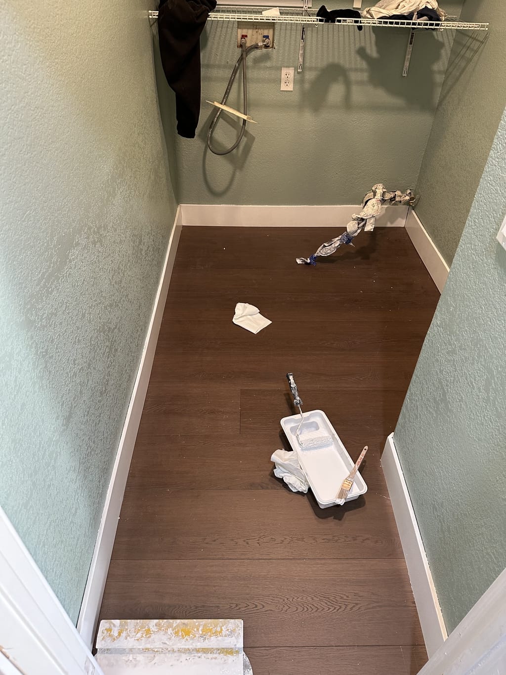 Sage-green laundry area with fresh paint, new flooring and white trim in Camarillo, CA 93010